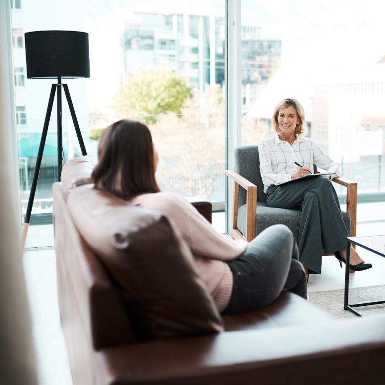 Shot of a mature psychologist having a therapeutic session with her patient.